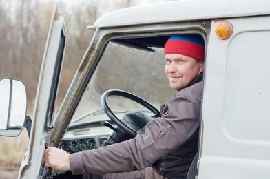 A truck driver at the wheel of his rig